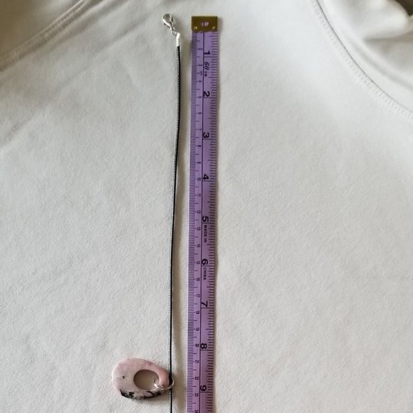 Pink rhodonite gemstone with black veining, natural pendant on a black cord. - Picture 5 of 6